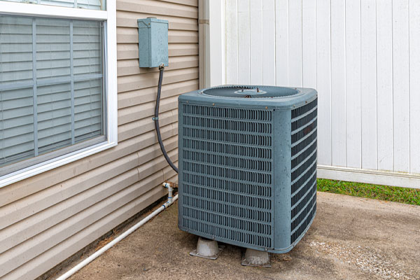 Air conditioner condenser unit being serviced in Aurora, CO