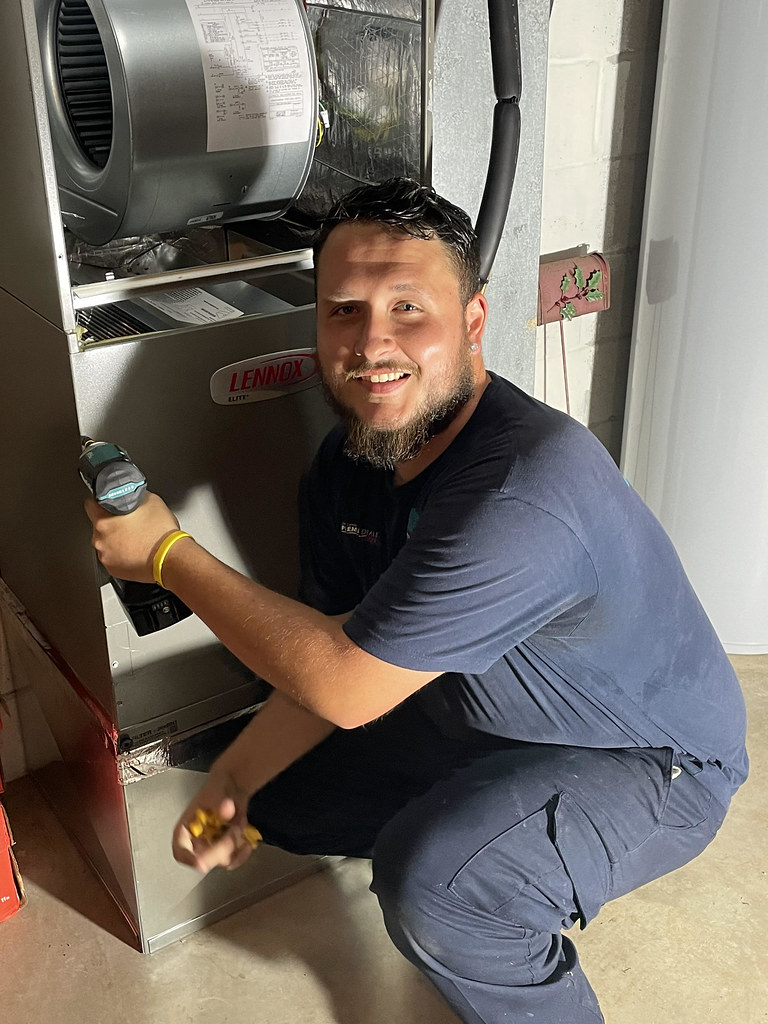 PeakLine technician inspecting an indoor air handler unit